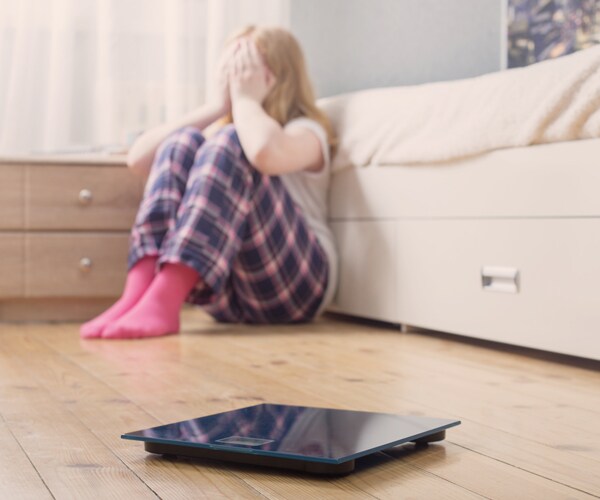 a teenage girl crying on the floor