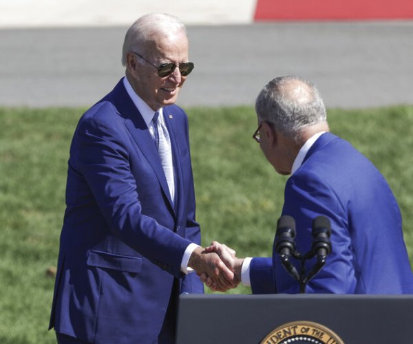 president joe biden shakes hands with senate majority leader chuck schumer