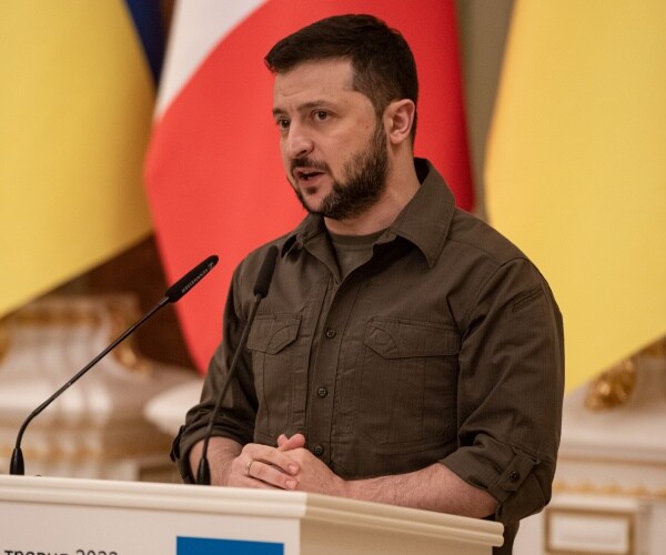 volodymyr zelenskyy speaks into a microphone