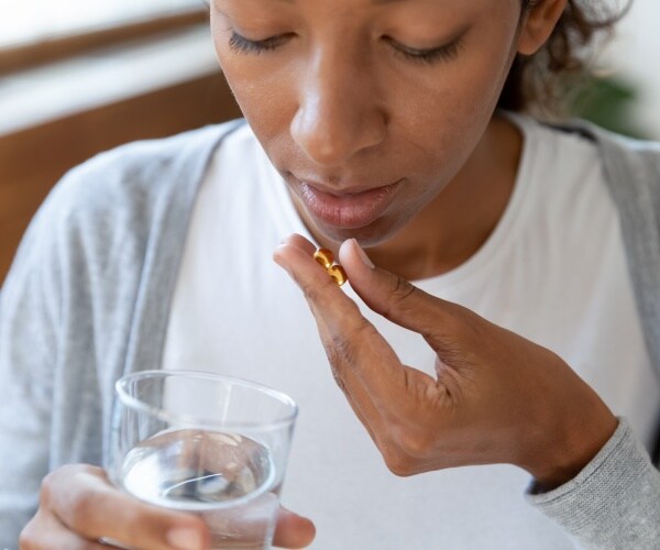 woman taking vitamin D