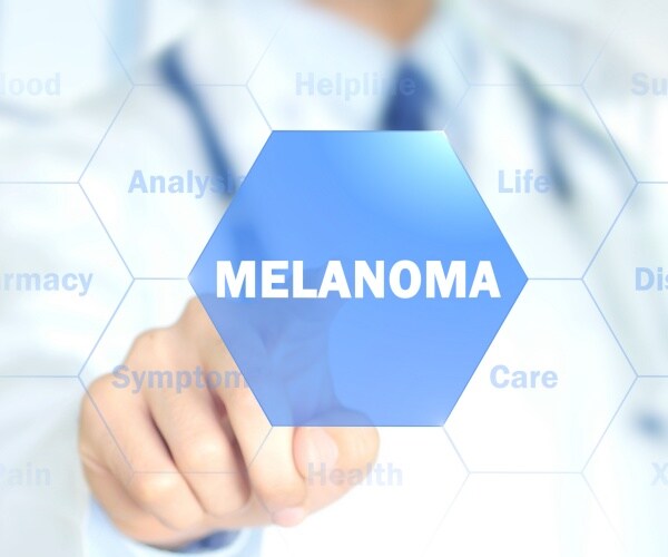 physician touching 'melanoma' on screen