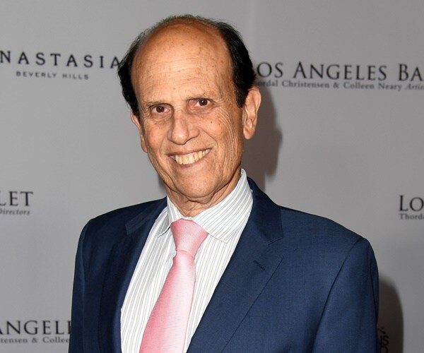 michael milken poses for a photo at an event