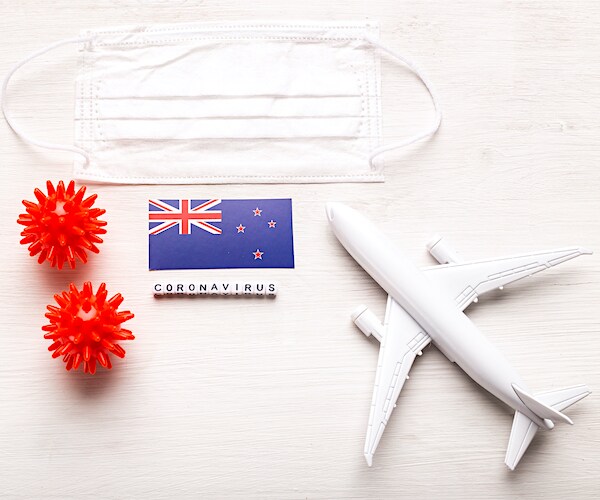 a graphic illustration of the new zealand flag, a plane and the coronavirus