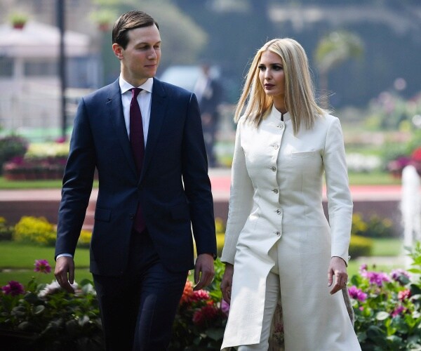 ivanka trump in a white outfit and jared kushner in a navy suit and maroon tie walk in new delhi, india