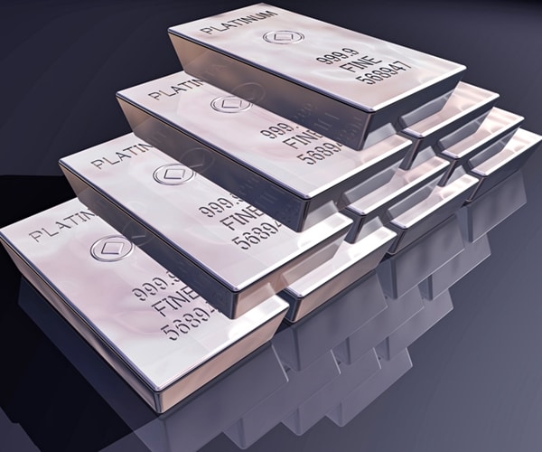 stack of pure platinum bars on a reflective surface. 