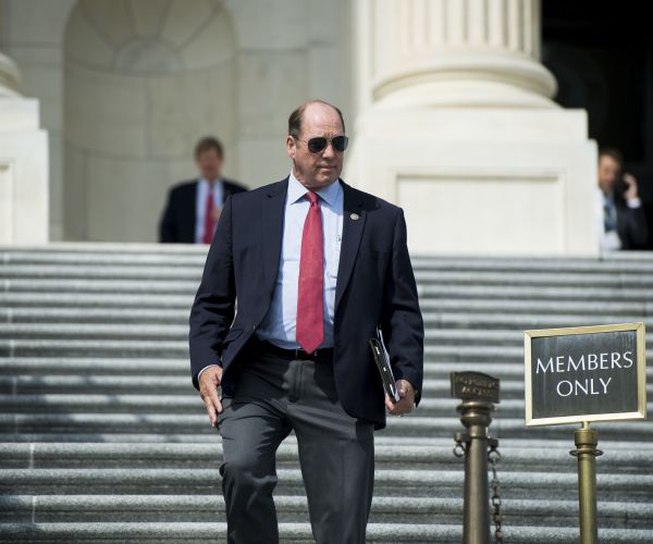 ted yoho walks down the steps out in front of capitol hill