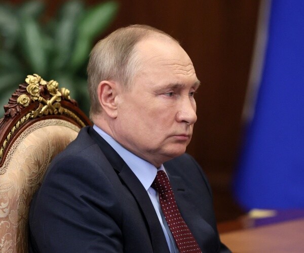 Vladimir Putin attends a meeting