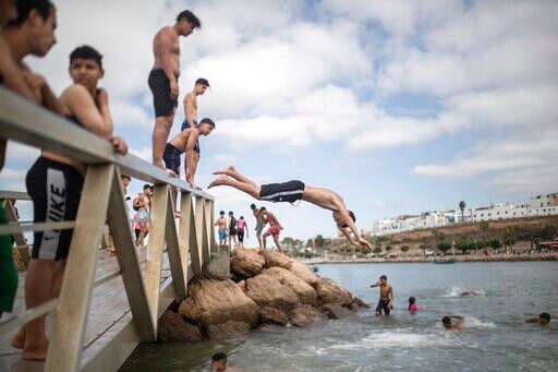 AP PHOTOS: Moroccans Swim, Sing, Reconnect as Lockdown Lifts