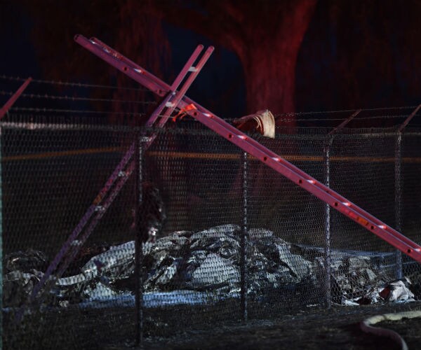 remnants of airplane near a fence