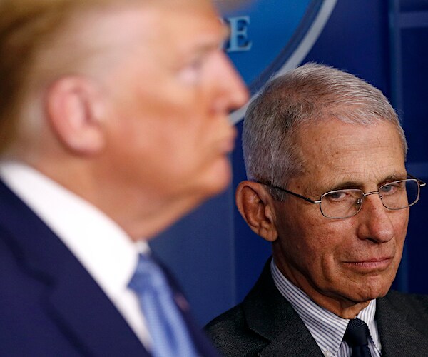 Dr. Anthony Fauci casts a skeptical eye at President Donald Trump