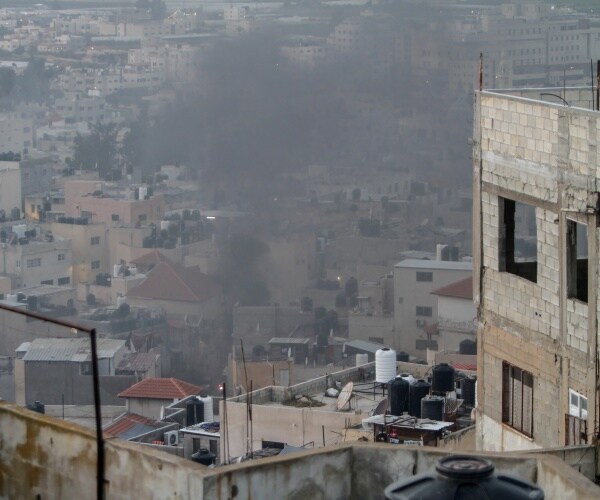 smoke rises up from a house