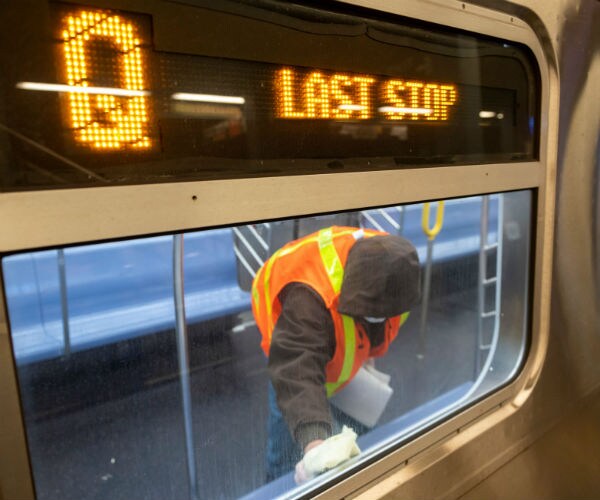 a transit worker cleans a subway car at coney island