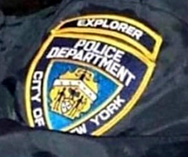 a badge of a new york police department explorer on a jacket