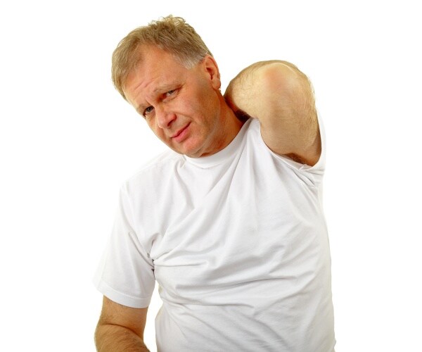 man itching his back