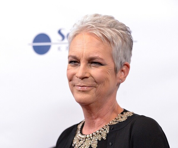 jamie lee curtis stands on red carpet