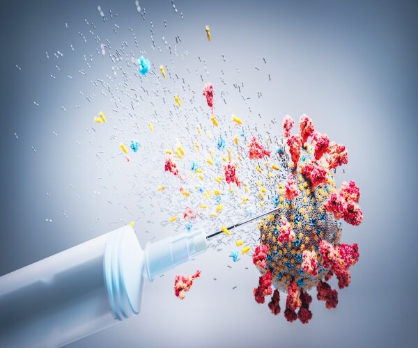 Image of a vaccine needle in the coronavirus breaking it apart