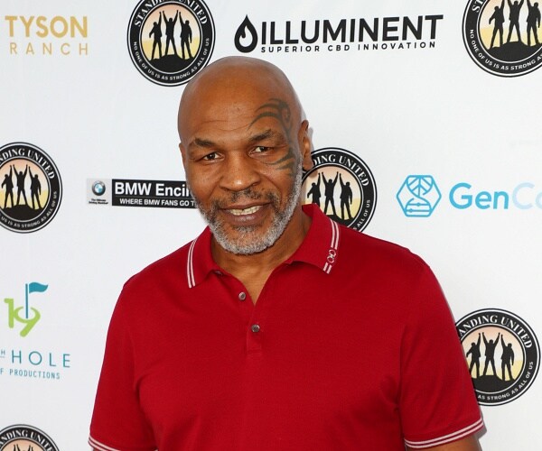 mike tyson stands on red carpet