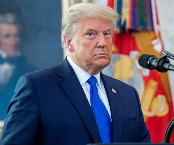 donald trump stands at podium in oval office