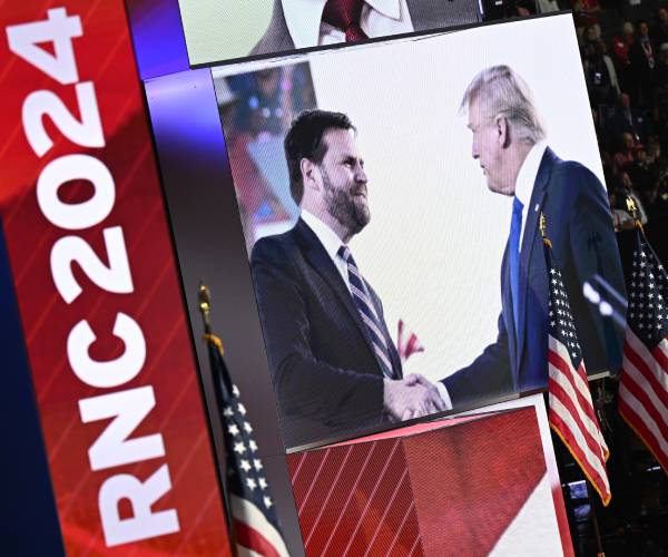 jd vance and donald trump on a screen at the republican national convention