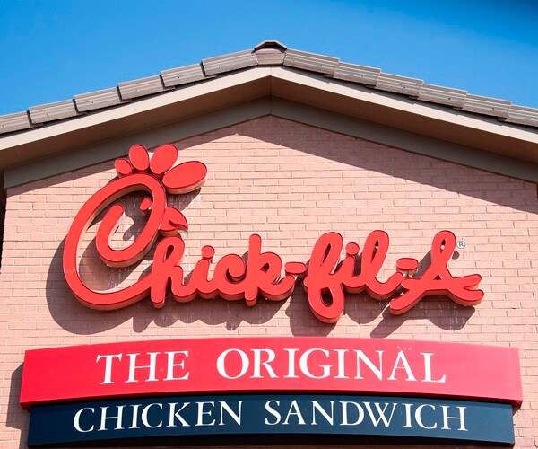 a chick-fil-A sign on the side of a restaurant building