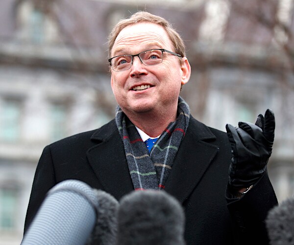 kevin hassett gestures with his right hand and smiles during a news conference on the economy