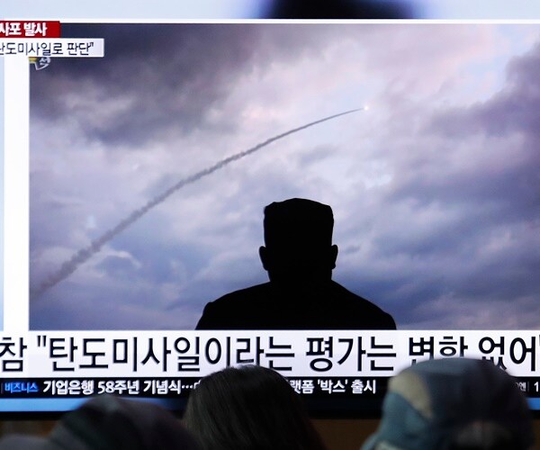 people watch a north korean missile launch on tv in south korea