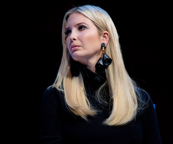 ivanka trump stands against black on stage