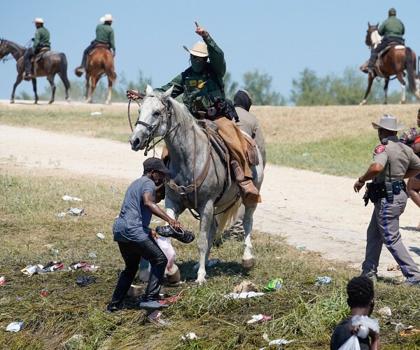 mounted border patrol agent tries to stop migrant from coming ashore
