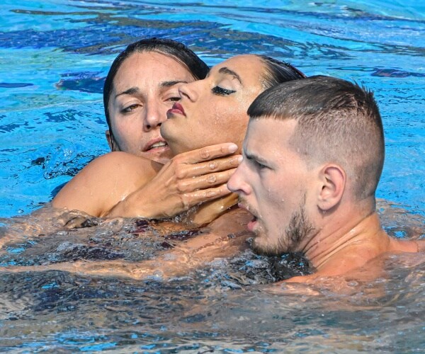 three swimmers in a pool