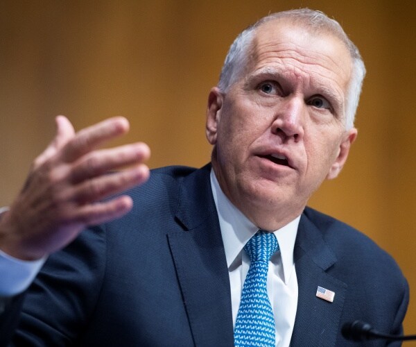 tillis in a suit and blue tie