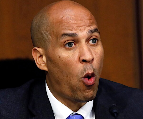 new jersey democratic senator cory booker exults with an open mouth and angry eyes