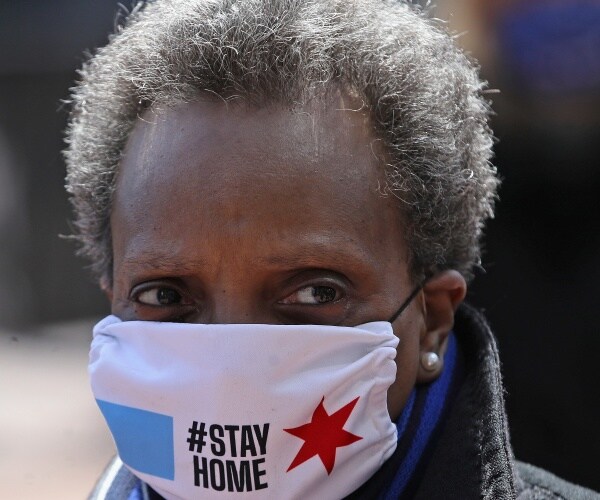 lori lightfoot stands in wrigley field