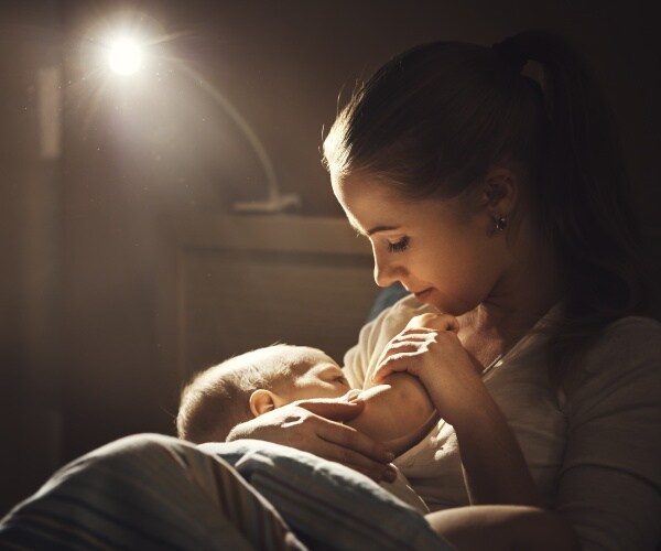 woman breastfeeds her baby