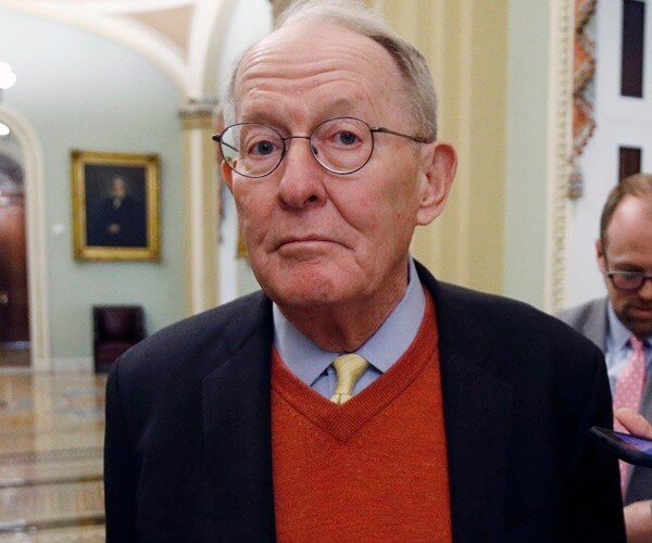 sen. lamar alexander walks through congress with reporters in tow