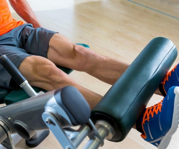 man doing leg lift machine