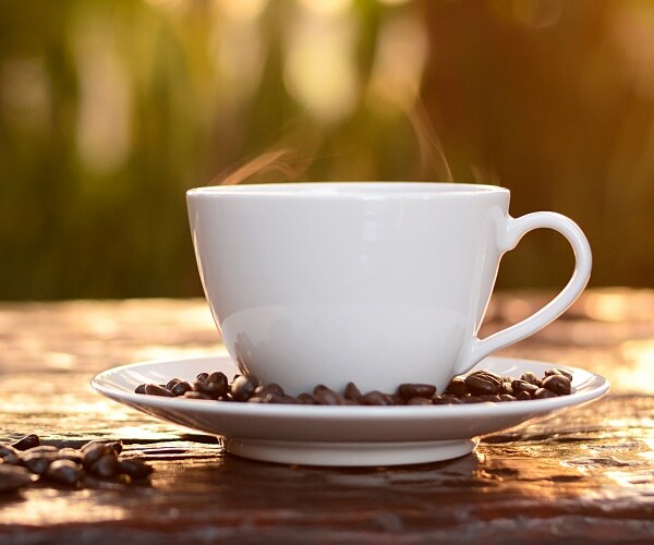 cup of hot coffee on table outdoors