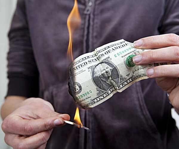 burnning the money. one dolar bill