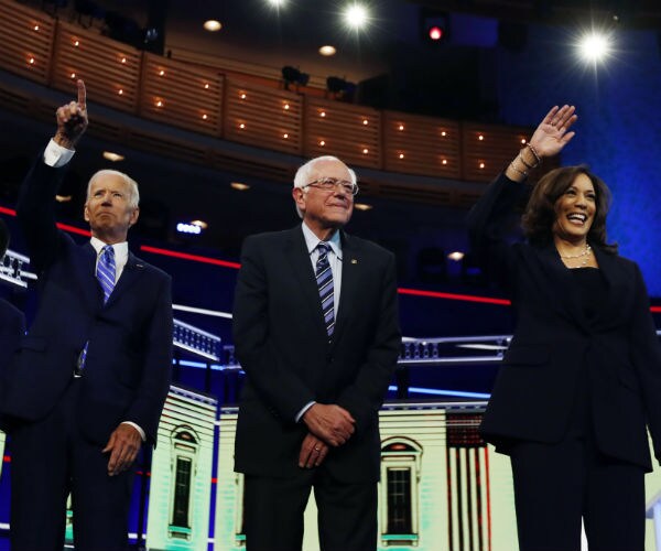 joe biden, sen. bernie sanders, and sen. kamala harris are shown at one of the democratic debates 