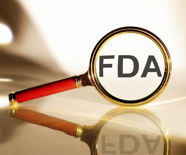 magnifying glass with 'FDA' magnified