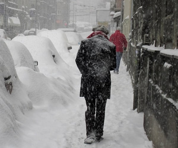 person walking in snow storm