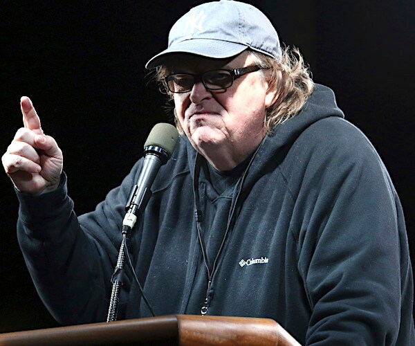 michael moore points and speaks from a podium