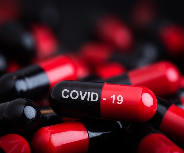 black and red capsules, one says COVID-19