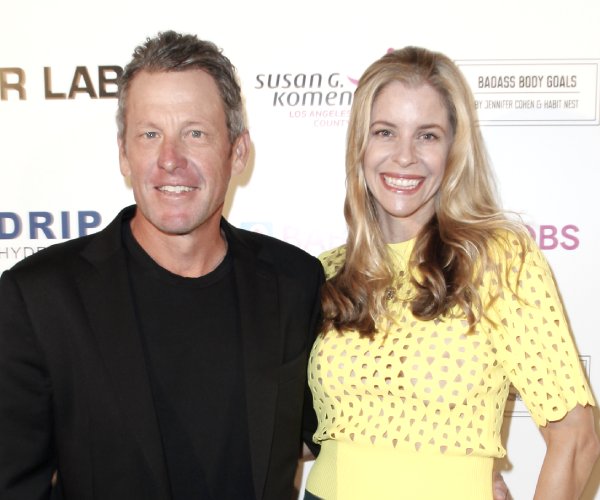 lance armstrong and anna hansen arrive at a benefit auction