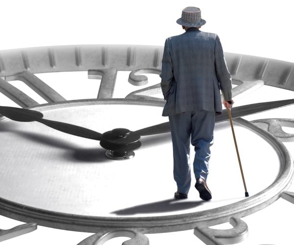 a senior walking on an enlarged clock depicting aging, retirement and time