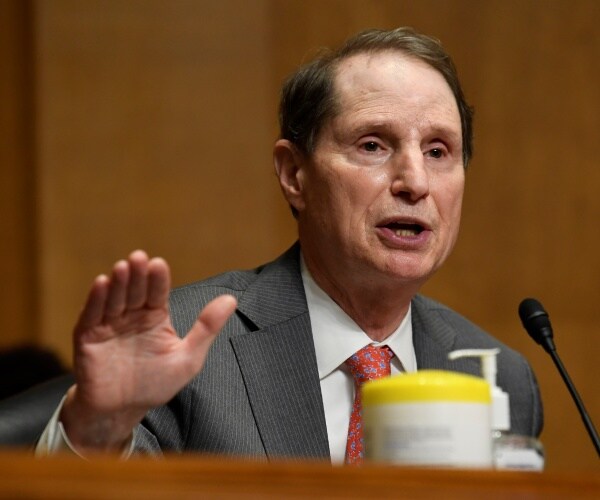 wyden in a gray suit and red patterned tie