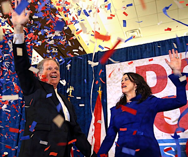 alabama democratic senator doug jones celebrates on election night amid a cloud of confetti