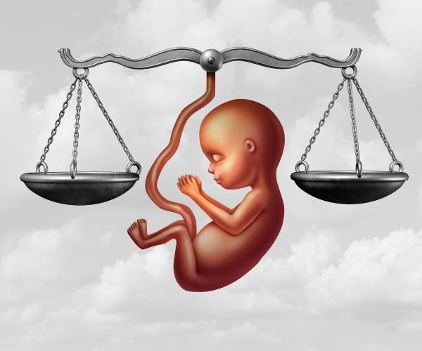 illustration of a fetus between the scales of justice