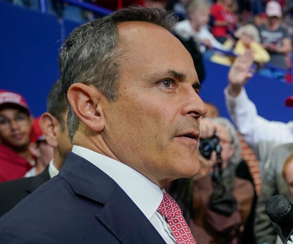 Matt Bevin stands and listens during a campaign rally