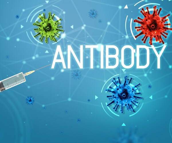 syringe with antibody treatment pointing at three COVID virus particles