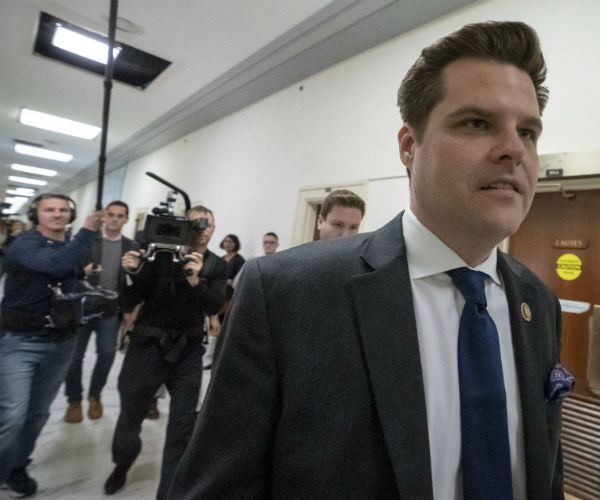 matt gaetz is shown walking past reporters
